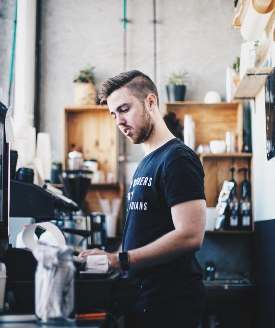 A business owner behind the counter of his own shop